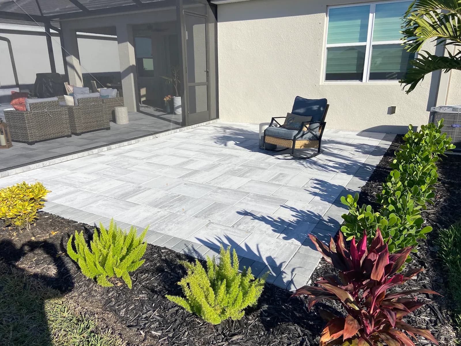 Backyard paver patio with fresh landscaping in Ellenton, FL