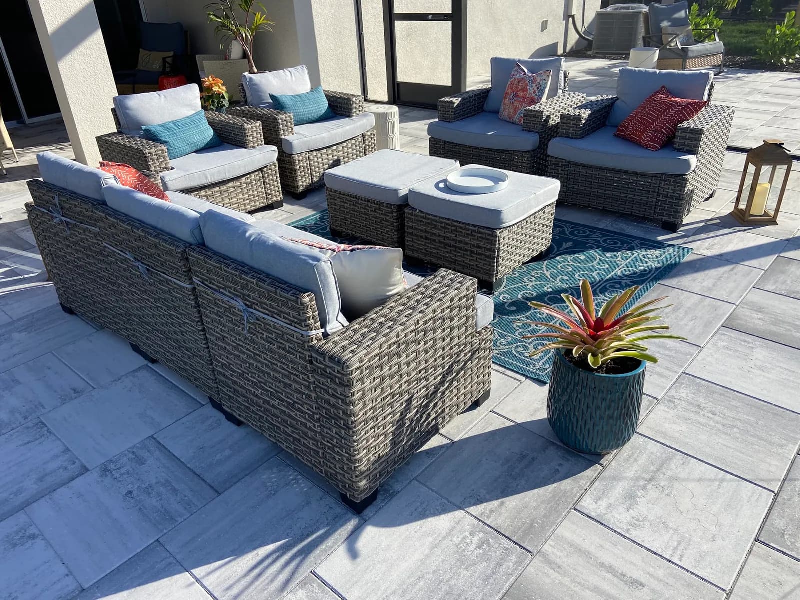 Covered lanai lounge with paver flooring and outdoor sectional in Parrish, FL